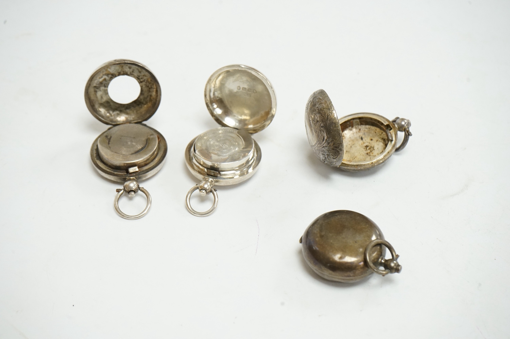 Four assorted late 19th/early 20th century silver circular sovereign cases, including Birmingham, 1885, 1903 and 1910 and Chester, 1915. Condition - poor to fair